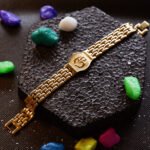 Close-up of AuraSpark Spiritual Om Wristband in Gold Finish