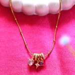 Gold AuraSpark necklace with pink heart and star charms