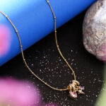 Celestial gold satellite chain with purple and pink crystals.