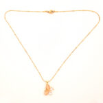 Dainty gold butterfly necklace for women with peach stones.