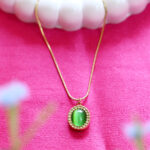 Vintage emerald green cabochon pendant with crystal halo