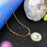 AuraSpark Gold Herringbone Necklace with Teal Rose Pendant