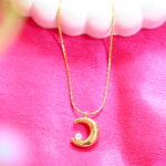 Close up of sparkling moon and star necklace by AuraSpark