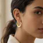 Gold tapered ribbon hoop earrings with secure hinged back