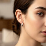 AuraSpark minimalist faceted silver hoops with hinge closure.