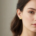 Polished gold butterfly jewelry on white background