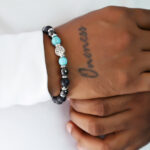 Black Lava Rock essential oil diffuser bracelet with silver charm.