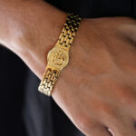 AuraSpark Men's Gold Om Bracelet with Stainless Steel Links.