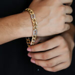 Men's two-tone gold and silver Figaro link chain bracelet.