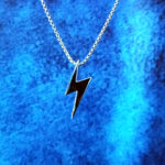 Polished stainless steel flash charm on a silver box chain