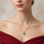 AuraSpark gold necklace with oval green emerald pendant.