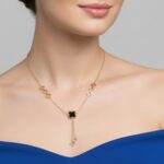 AuraSpark gold lariat necklace with black clover charms for women