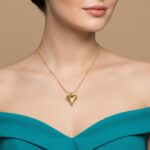 AuraSpark 18K gold puffy heart pendant on beaded snake chain.